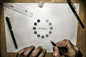 A "loading" circle around the word "thinking."